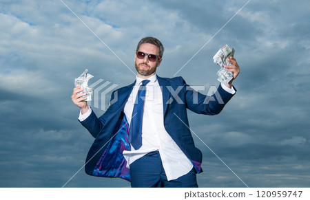 millionaire man with money on sky background. millionaire man with money outdoor millionaire man with money on sky background. millionaire man with money outdoor 120959747