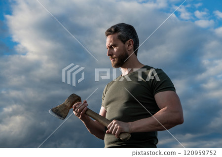 man with axe. craftsman man hold ax. brutal man on dramatic sky background 120959752