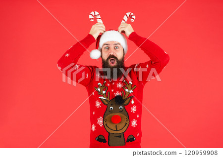 merry christmas. shocked bearded man in santa claus hat. brutal hipster in winter xmas sweater. merry christmas. shocked bearded man in santa claus hat. brutal hipster in winter xmas sweater. 120959908