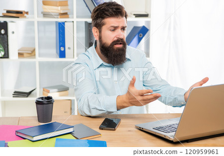 Disappointed businessman working on laptop at office desk, work Disappointed businessman working on laptop at office desk, work 120959961