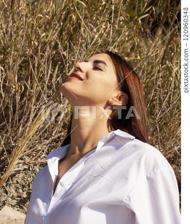 young brunette girl having fun on seacoast, lifestyle people concept close up young brunette girl having fun on seacoast, lifestyle people concept close up 120960348