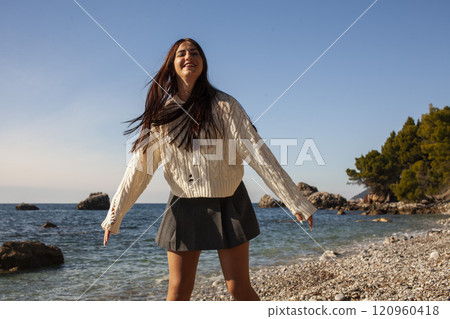 young brunette girl having fun on seacoast, lifestyle people concept close up 120960418