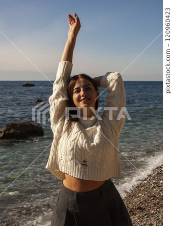 young brunette girl having fun on seacoast, lifestyle people concept close up young brunette girl having fun on seacoast, lifestyle people concept close up 120960423