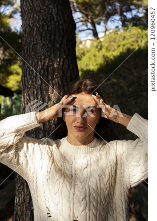 young brunette woman outside in green park sunny day, lifestyle people concept close up 120960457