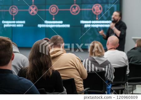 Audience listening to a speaker during a business presentation in conference room Audience listening to a speaker during a business presentation in conference room 120960809