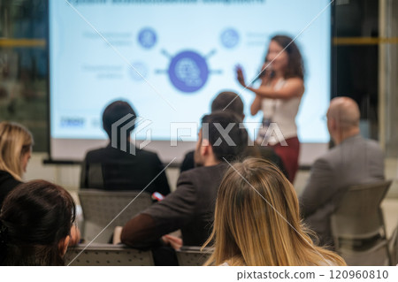 Business presentation with audience listening to female speaker in conference room Business presentation with audience listening to female speaker in conference room 120960810