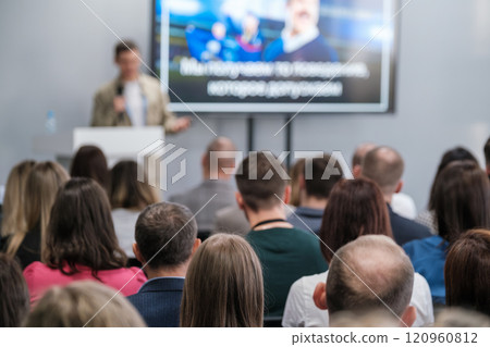 Audience attentively listening to speaker during professional conference presentation Audience attentively listening to speaker during professional conference presentation 120960812