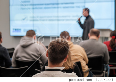 Audience attentively listens to speaker during educational business seminar 120960821