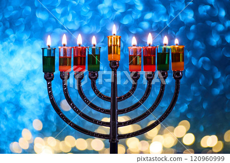 Hanukkah Menorah with burning candles on dark background with bokeh lights. 120960999