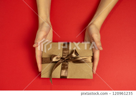 female hands holding certificate with brown bow, gift certificate, gift voucher or discount female hands holding certificate with brown bow, gift certificate, gift voucher or discount 120961235
