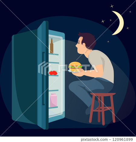 A man sits in front of an open refrigerator at night and eats a burger 120961899