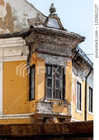 Old crumbling house exterior facade with windows. Old crumbling house exterior facade with windows. 120962127