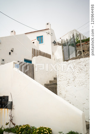 From below of white houses and steps in small town 120964498
