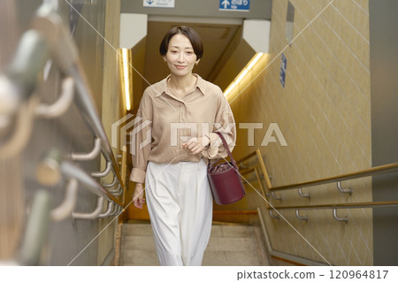 Woman climbing the subway stairs 120964817