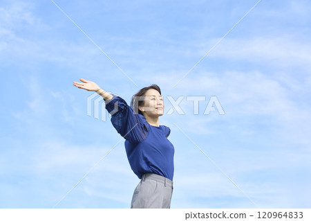 A woman taking a deep breath outside A woman taking a deep breath outside 120964833