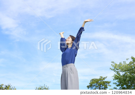 A woman taking a deep breath outside A woman taking a deep breath outside 120964834