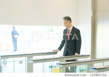 People passing through the security gate at the office 120965318