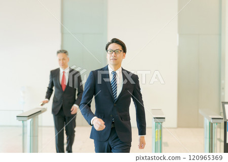 People passing through the security gate at the office 120965369