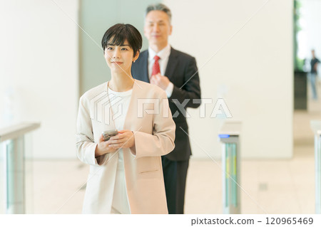 People passing through the security gate at the office 120965469