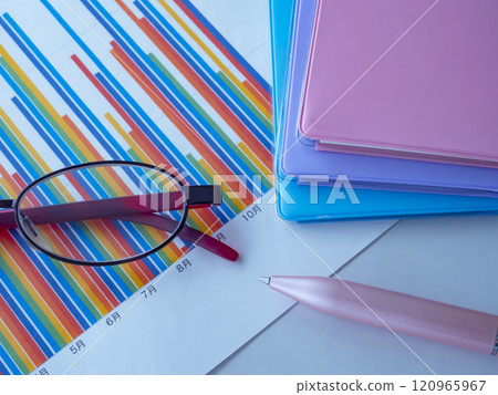 Graph, notebook and glasses on the table Graph, notebook and glasses on the table 120965967