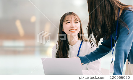 Two women/businesswomen using a laptop Two women/businesswomen using a laptop 120966050