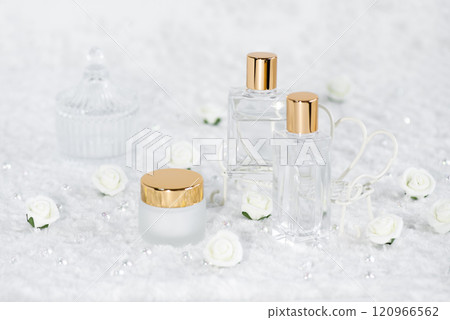 Glass container of skin care products and rose flower 120966562