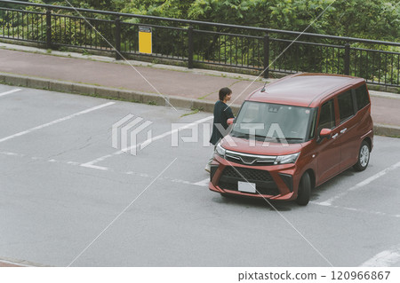 Woman returning to her car in the parking lot 120966867