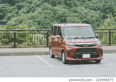 A woman backing up her car into a parking lot A woman backing up her car into a parking lot 120966875