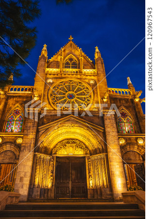 medieval Catholic cathedral in French village in Ba Na Hills Park in Da Nang in Vietnam at night medieval Catholic cathedral in French village in Ba Na Hills Park in Da Nang in Vietnam at night 120967543