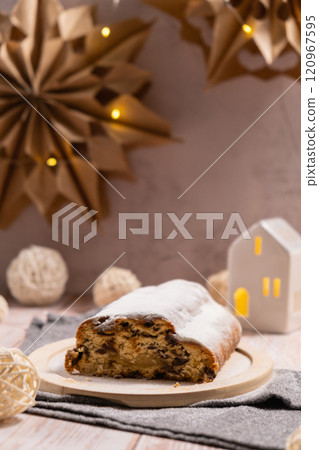 Homemade Christmas traditional cake pie with marzipan nuts and dried fruits pastry dessert stollen. Winter holidays season atmosphere. Delicious tasty composition home table setting 120967595