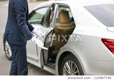 Driver opening the back door of a car Driver opening the back door of a car 120967746