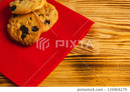 Delicious cookies with raisins on a red napkin, Christmas concept Delicious cookies with raisins on a red napkin, Christmas concept 120968279