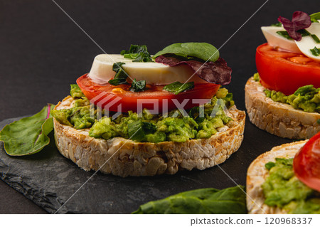 Vegan food concept, rice cakes with fresh vegetables on black background 120968337