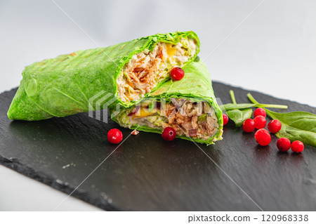 Healthy food, fresh pita roll with grilled chicken, vegetables and cranberries Healthy food, fresh pita roll with grilled chicken, vegetables and cranberries 120968338