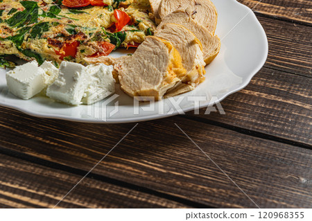 Delicious healthy hot breakfast, omelet with tomatoes and spinach chicken cheese 120968355