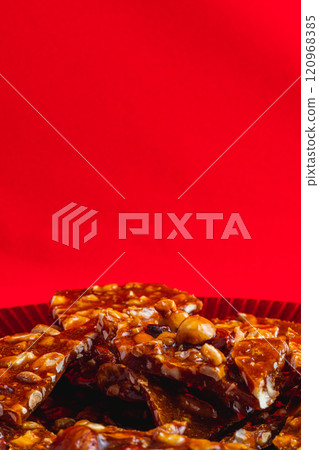 Homemade sugar cookies with nuts on a shiny red plate Homemade sugar cookies with nuts on a shiny red plate 120968385