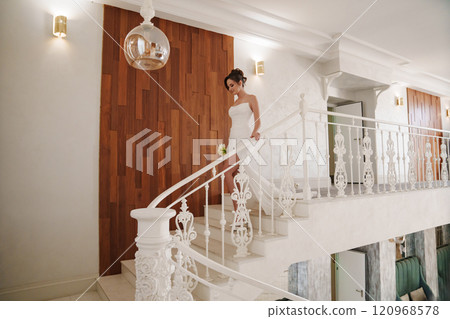 a Beautiful and happy bride on a large beautiful staircase. 120968578