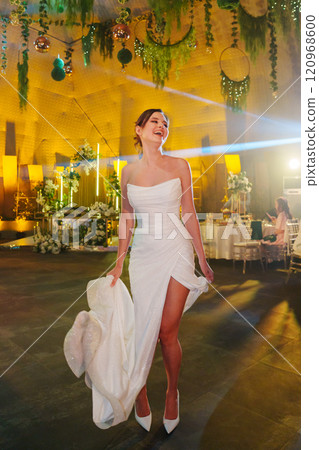Beautiful and happy bride dancing in restaurant at wedding. Beautiful and happy bride dancing in restaurant at wedding. 120968600