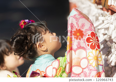A 7-year-old girl tying her fortune at the Shichigosan festival 120968743