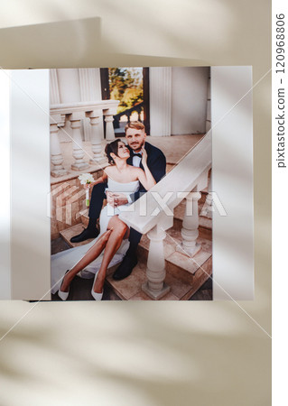 page of an open photo book with wedding photos on a white table page of an open photo book with wedding photos on a white table 120968806
