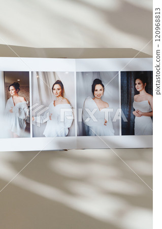 page of an open photo book with wedding photos on a white table page of an open photo book with wedding photos on a white table 120968813