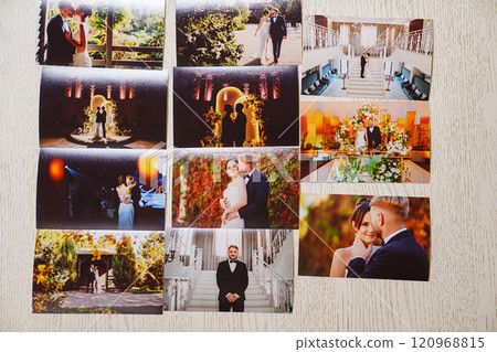 Printed wedding photos laid out on a wooden surface. Printed wedding photos laid out on a wooden surface. 120968815
