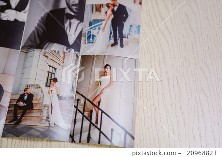 Printed wedding photos laid out on a wooden surface. Printed wedding photos laid out on a wooden surface. 120968821
