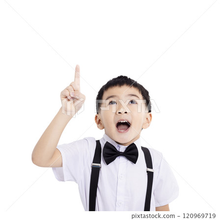 Portrait of amazed cute school boy pointing to empty place on white background Portrait of amazed cute school boy pointing to empty place on white background 120969719