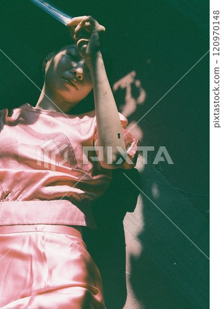 Person looking at reversal film in a dark room Person looking at reversal film in a dark room 120970148