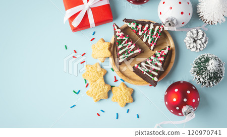Christmas chocolate brownies and cookies with christmas decor on blue background 120970741