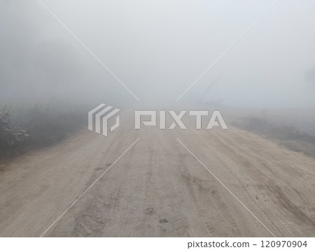 Dirt road in rural on a heavy foggy day Dirt road in rural on a heavy foggy day 120970904