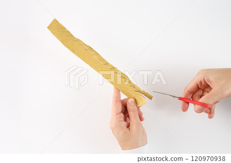 a crafting or DIY activity, specifically the process of cutting a patterned material. It could be part of a larger project, such as making decorations or creating a specific design. 120970938