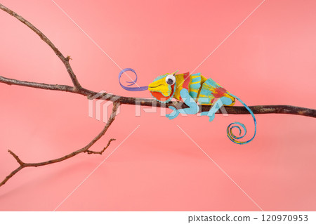 an up-cycled egg box iguana craft or chameleon toy on pink background, 120970953