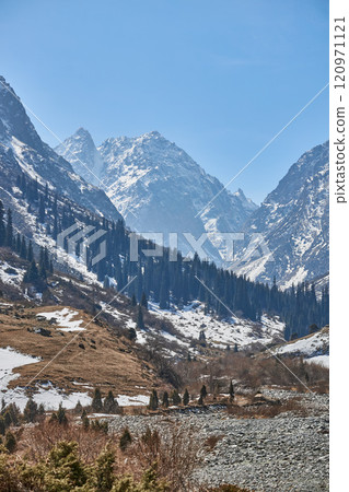 Spring landscape nestled within a majestic mountain valley 120971121